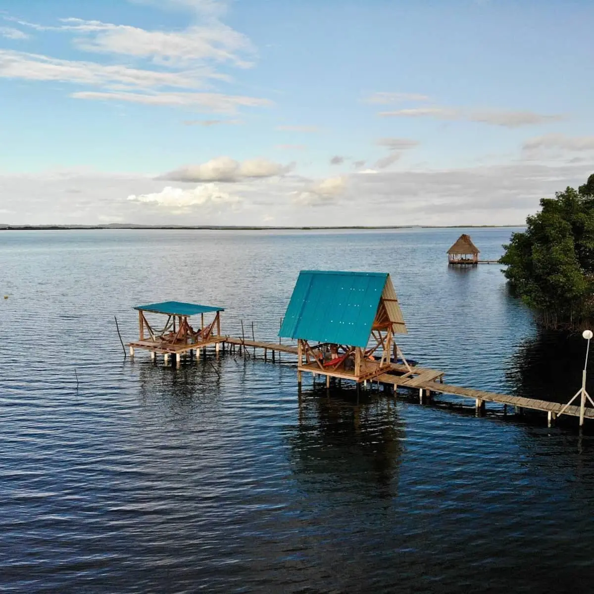 Long dock leading to an over-water cabin and gazebo