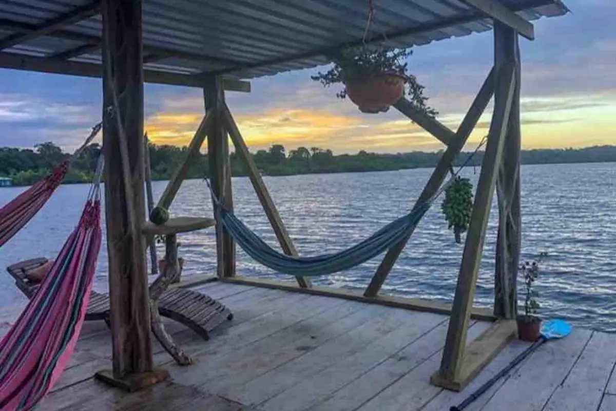 Hammocks on a covered dock over the bay at sunset